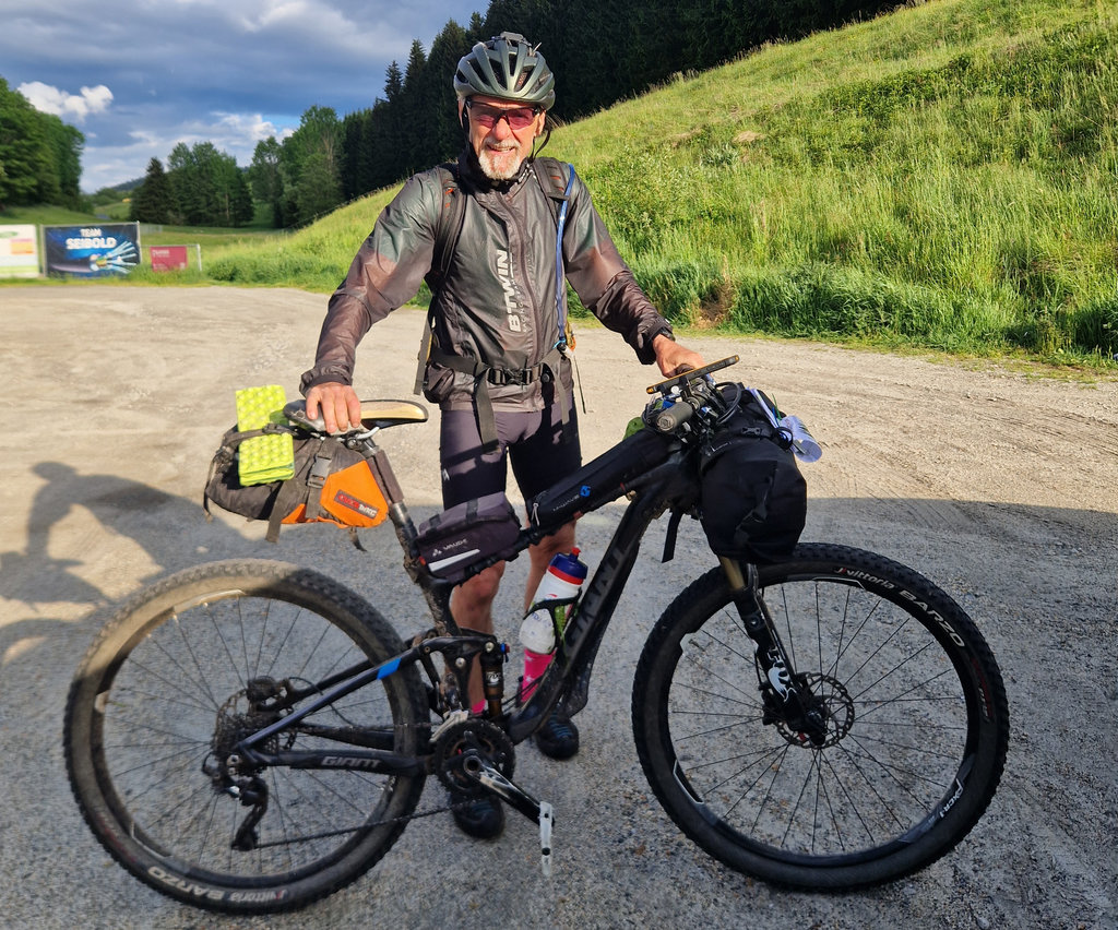 Rider with a loaded mountain bike ready for bikepacking